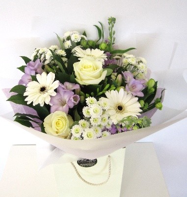 Scented bouquet including white roses, lilac freesia, white germini and chrysanthemums. 