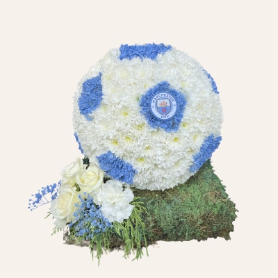 3D football funeral tribute with white chrysanthemum base, hexagonal print, turf-effect base, and optional team logo. 