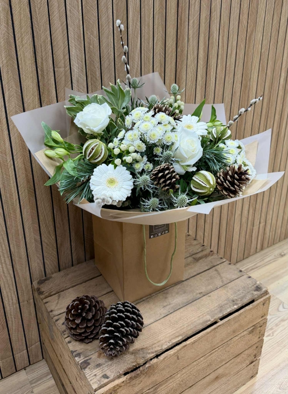 Luxury all-white Christmas bouquet with natural alpine textures and winter greenery.