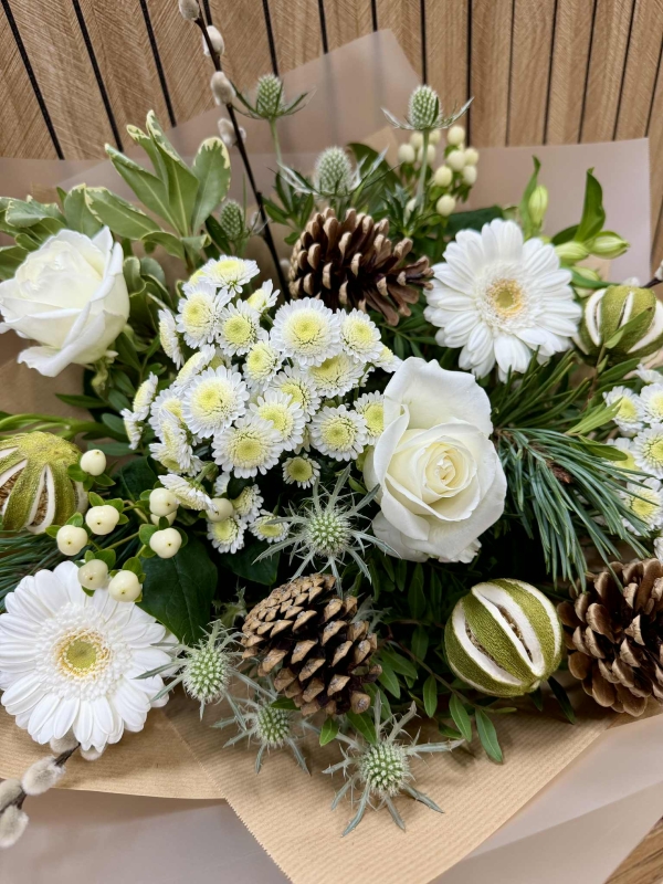 Luxury all-white Christmas bouquet with natural alpine textures and winter greenery.