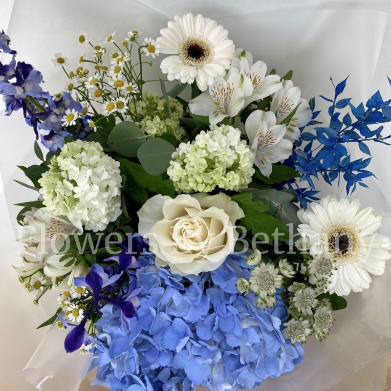 Stunning mixed blue & white bouquet filled with roses, hydrangea, delphinium, Astrantia, dried ruscus, alstroemeria,  matricaria, viburnum and germini. Hand tied in water, presented in our signature gift bag and wrap. 