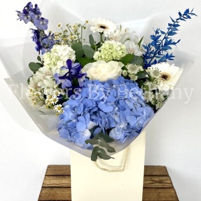 Stunning mixed blue & white bouquet filled with roses, hydrangea, delphinium, Astrantia, dried ruscus, alstroemeria,  matricaria, viburnum and germini. Hand tied in water, presented in our signature gift bag and wrap. 