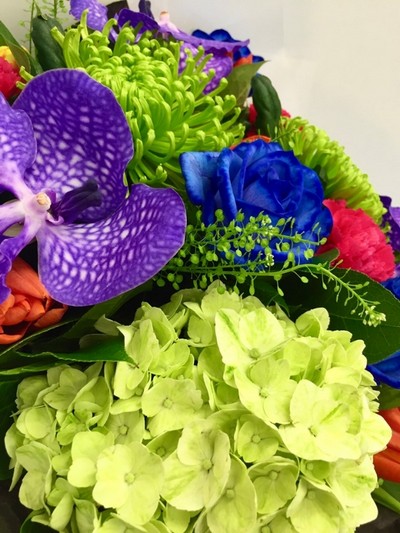 Extraordinary hand tied including blue roses, purple vander orchids and a mix of traditional vibrant flowers. 