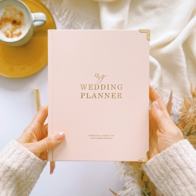 Blush & Gold Blush wedding planner with soft blush pink cover and gold detailing.
