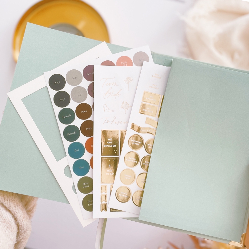 Blush & Gold Eucalyptus wedding planner with green botanical cover and gold detailing.