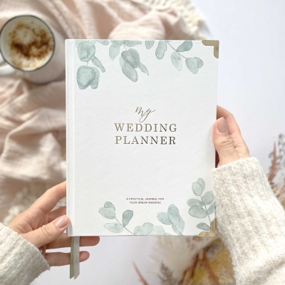 Blush & Gold Eucalyptus wedding planner with green botanical cover and gold detailing.