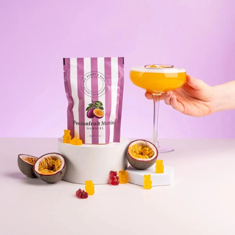 Ask Mummy & Daddy Passionfruit Martini cocktail gummies, palm-oil-free, gluten-free and dairy-free, in a purpe and white stripe gift pouch.