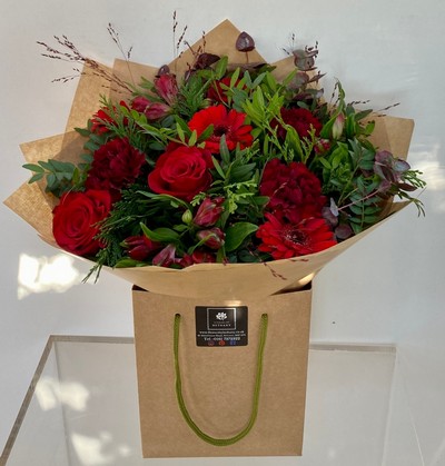 Roses, germini, carnation and alstroemeria with complimentary foliage to finish the design. 