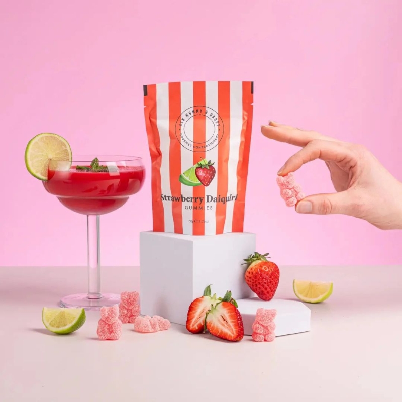 Ask Mummy & Daddy Strawberry Daiquiri palm-oil-free, gluten-free, dairy-free cocktail gummies in a red and white stripe gift pouch.