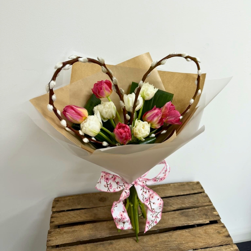 Pink and white tulip bouquet with a handcrafted pussy-willow heart, wrapped in luxury paper and tied with a patterned ribbon.