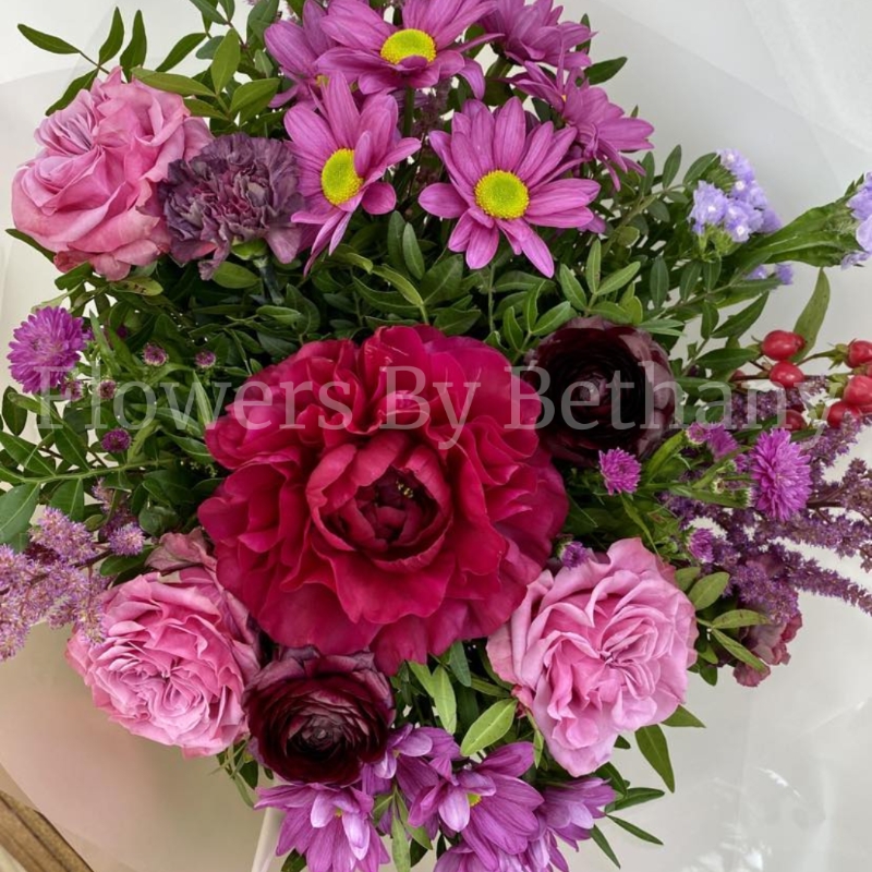 Bouquet filled with rich pink and purple toned florals including peonie, rose, astilbe and carnation. Hand tied in water, presented in our signature gift bag and wrap. 