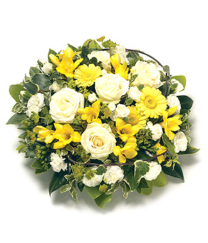 Mixed yellow and white funeral posy including rose, carnation and chrysanthemum. 