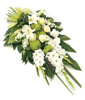 Modern flat spray funeral tribute in fresh white and green florals. 