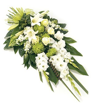 Modern flat spray with gladioli, roses, chrysanthemums, and stocks, complemented by foliage.
