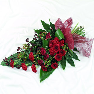 Red flat bouquet including roses, germini and kangaroo paw. 