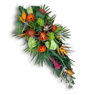 Tropical casket spray with vibrant florals and tropical foliage.