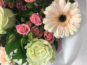 Floral favourites including roses, wax flower, germini and lisianthus in soft tones. 