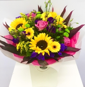 Hand tied bouquet in zesty vibrant colours. Including roses, sunflowers and solidago. 