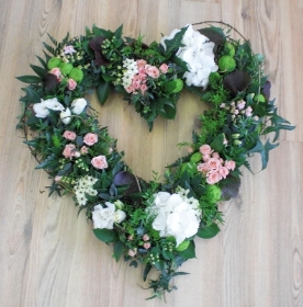 Open textured heart with natural foliage and touches of pure white and light pink florals. 