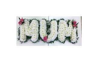 Foliage edge MUM lettering with white chrysanthemum and pink focals. 