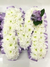 Lilac ribbon edged MUM funeral tribute with lilac lisianthus focal flowers. 