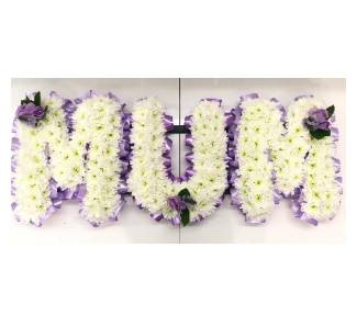Lilac ribbon edged MUM funeral tribute with lilac lisianthus focal flowers. 