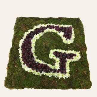 Letter-shaped funeral tribute on a 24