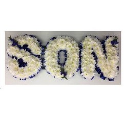 SON Funeral lettering with white chrysanthemum base and deep blue focal and ribbon edging. 