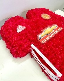 Manchester United football shirt funeral tribute created with chrysanthemum and waterproof badges and logos. 