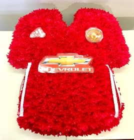 Manchester United football shirt funeral tribute created with chrysanthemum and waterproof badges and logos. 