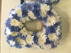 Checked DAD funeral tribute with mixed blue and white flowers and matching blue ribbon edge. 