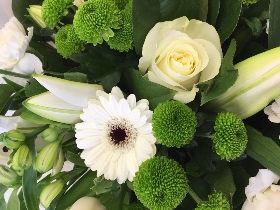 Hand tied bouquet including a mix of pure white and green favourites such as lilies, roses, germini and carnations. 