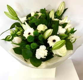 Hand tied bouquet including a mix of pure white and green favourites such as lilies, roses, germini and carnations. 