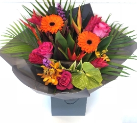 A beautiful mix of tropical and traditional, including heliconias and gingers, with germini and roses. 