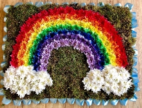 Rainbow funeral tribute created using sprayed chrysanthemum in all the colours of the rainbow. 