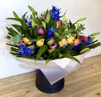 Luxury hand tied of lily, calla lily, delphinium and roses. 