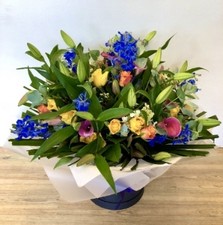 Luxury hand tied of lily, calla lily, delphinium and roses. 