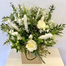 Natural hand tied bouquet in white tones including roses, stocks and pampas grass. 