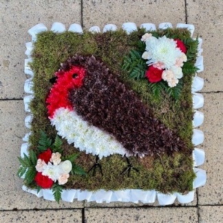 Beautifully designed red robin funeral tribute with moss background and spray paint detailing. 