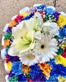 Beautiful speckled rainbow heart funeral tribute made with chrysanthemum and finished with a white ribbon edge and focal. 