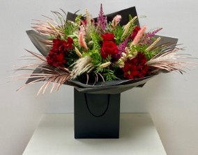 This bouquet is natural and wild, filled with wheat, pampas grass, red roses and astilbe. 