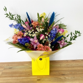 Stunning mixed vibrant bouquet including blue pampas, daisy's and pink roses bringing that zing into your loved ones life. 