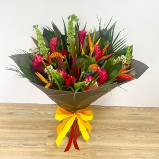 This tropical bouquet is the perfect luxury fix for those craving some summer vibes, including ginger, heliconia, palms and thistle. 