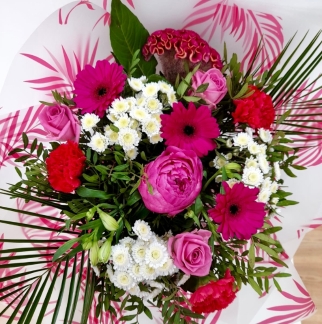 Stunning seasonal bouquet including peony, roses, germini and palms in pink and white tones. 