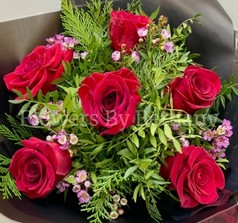 Bouquet featuring 6 luxury red roses with pink wax flowers, accented with diamanté in the roses, complemented by foliage, wrapped in luxury cellophane and matching gift bag, hand-tied in water.