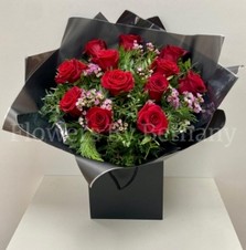 Dozen luxury red roses with fresh-scented wax flowers, accented with diamanté and complementary foliage, wrapped in luxury cellophane and matching gift bag, hand-tied in water.