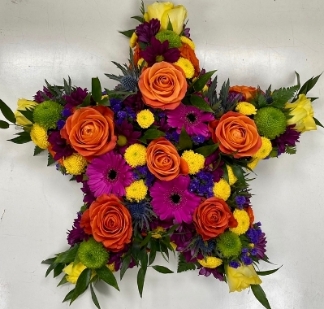 Stunning mixed floral star funeral tribute including roses, chrysanthemum, thistle and mixed foliage. 