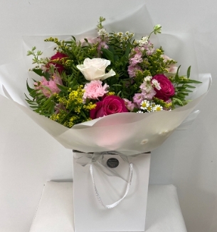 Stunning bouquet including pink roses, yellow solidago and white matricaria daisy wrapped in luxury cellophane and hand tied in water. 