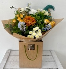 Sweater weather including rusty orange and rich teal colours. Spray rose, blooms, delphinium and pampas grass work perfectly together in this hand tied bouquet in water. 