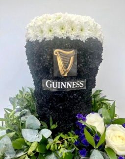3D Guinness funeral tribute, created with sprayed chrysanthemum and mixed foliage cushion base. 